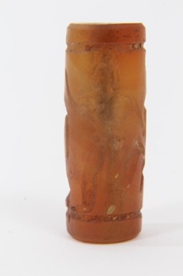 Lot 805 - Ancient carved carnelian cylinder seal, Near Middle East, carved with figures, approximately 3.5cm long