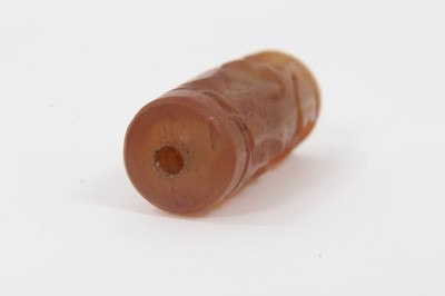 Lot 805 - Ancient carved carnelian cylinder seal, Near Middle East, carved with figures, approximately 3.5cm long