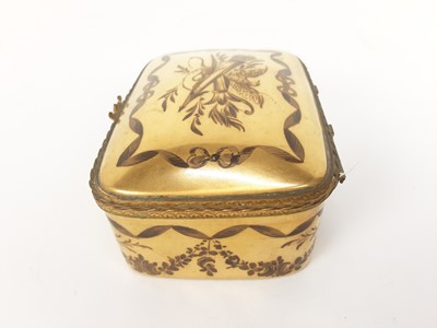 Lot 1931 - French ormolu-mounted porcelain box, late 19th century, probably Limoges, gilded and enamelled en grisaille with swags of flowers and other motifs, marks to base, 11cm across