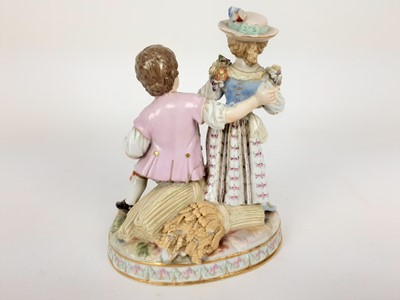 Lot 1932 - Meissen porcelain group, late 19th century, the boy sat on a sheaf of wheat, listening to a girl playing the lute, marks to base, 15cm high