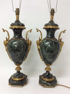 Lot 854 - Pair of 18th century style gilt metal mounted verde antico marble table lamps, each of urn form with twin scrolling handles and leaf moulded bands on shaped square plinth and bun feet, height to ba...