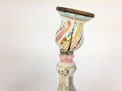 Lot 1937 - Pair of 18th century enamelled candlesticks, possibly Bilston, with spiralling knopped stems, painted with panels of flowers, 26.5cm high (a/f)