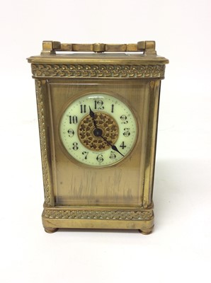 Lot 657 - Edwardian brass carriage clock with enamelled dial 14.5 cm high, key present