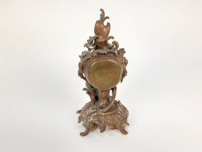 Lot 1949 - 19th century French brass mantel clock, decorated in the rococo style with a cherub, scrollwork motifs and flowers, with enamelled dial, 21.5cm high