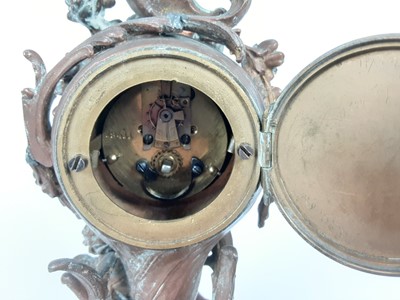 Lot 1949 - 19th century French brass mantel clock, decorated in the rococo style with a cherub, scrollwork motifs and flowers, with enamelled dial, 21.5cm high