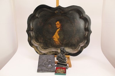 Lot 1955 - Large Victorian lacquered tray with a portrait of Napoleon, together with a lead plaque of Napoleon, a Napoleon paperweight, and a Wellington cast iron door stop (4)