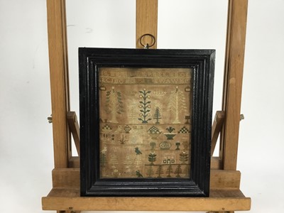 Lot 1908 - Adam and Eve sampler, dated 1798, in ebonised frame, together with a smaller sampler and a religious woolwork (3)