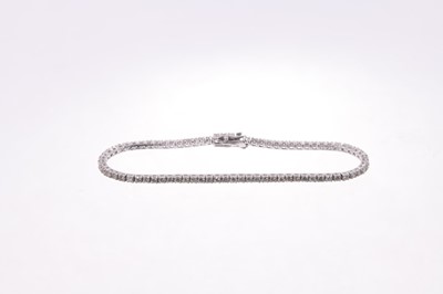 Lot 566 - Diamond tennis bracelet with a line of brilliant cut diamonds in 18ct white gold setting. Estimated total diamond weight approximately 2.60cts. Length 18cm.