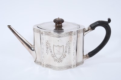 Lot 428 - George III silver teapot of shaped form, with engraved foliate decoration