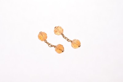 Lot 569 - A pair of citrine double cufflinks, each with two carved citrine beads, connected by chain links, marked '750'. Beads measure 1cm in diameter approximately, 7.2 grams, in pouch by Francioli, Genève...