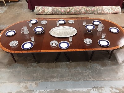 Lot 1517 - George III style mahogany crossbanded triple pedestal dining table, on spread supports and brass cappings and castors, to include two extra leaves, approximately 390 x 122cm when extended