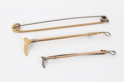 Lot 995 - 9ct gold riding crop tie pin, similar 9ct gold and silver riding crop tie pin and one other (3)