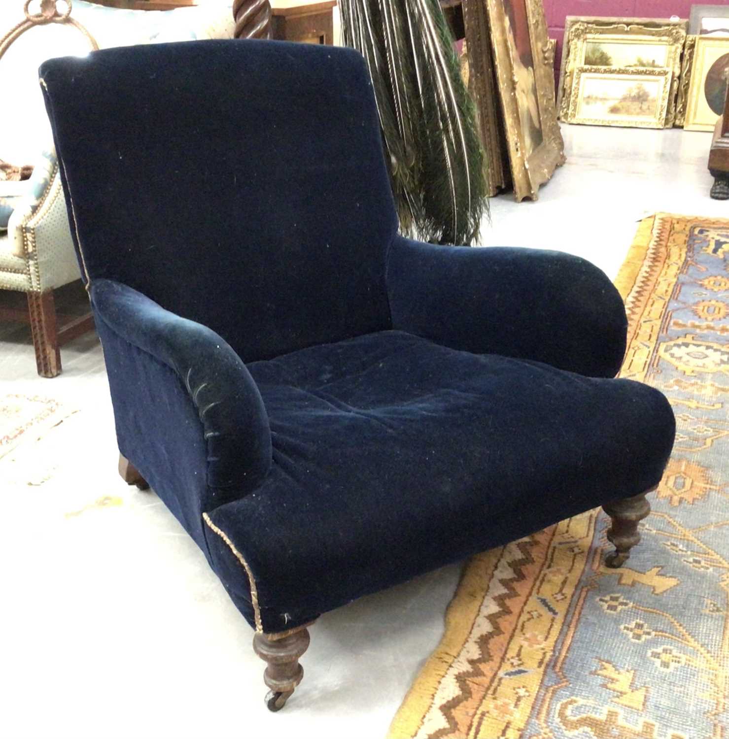 Lot 1566 - Late 19th / early 20th century oak upholstered deep armchair in the manner of Howard & Sons