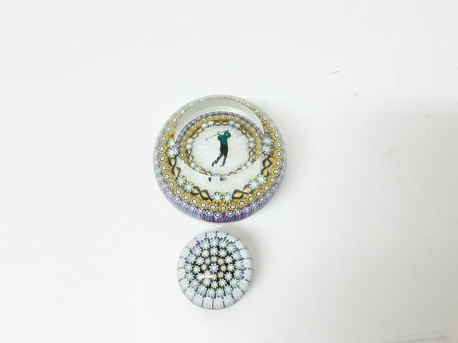 Lot 1130 - Good quality Perthshire Golfer paperweight with millifiori decoration and one other small Perthshire paperweight (2)