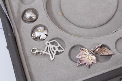Lot 270 - Collection of silver and white metal charms within a Stackers jewellery box