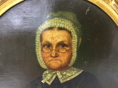 Lot 95 - English School, mid 19th century, oil on canvas, oval, portrait of an austere woman with glasses and white bonnet, 26 x 22cm, gilt frame