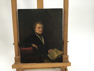 Lot 101 - English School, circa 1830, half length portrait of a Gentleman seated before an organ with music manuscript in hand, indistinctly inscribed in pencil verso, 30 x 23cm