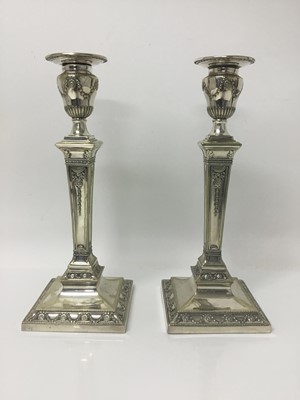 Lot 84 - Pair of late Victorian silver plated candlesticks with neoclassical decoration by Hawksworh Eyre & Co.