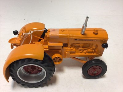 Lot 2365 - Arcade cast iron tractor and driver grey & red livery plus a Minneapolis Moline cast metal model of a tractor orange & red livery (2)