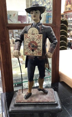 Lot 606 - Cast metal painted figure of a gentlemen with a clock strapped to his chest and back