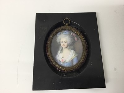 Lot 245 - 18th century style portrait miniature on ivory depicting a lady in blue dress, signed with initials AB, oval, 7 x 6cm, glazed metal frame suspended from ebonised frame, together with a similar 18th...