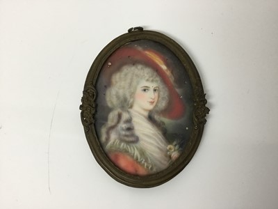 Lot 109 - 18th century style portrait miniature on ivory depicting a lady in blue dress, signed with initials AB, oval, 7 x 6cm, glazed metal frame suspended from ebonised frame, together with a similar 18th...