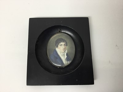Lot 247 - 18th century portrait miniature on ivory, depicting a Gentleman in blue coat and white cravat, oval, 6 x 5cm, together with an early 20th century portrait miniature of a lady named verso as Catheri...