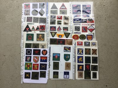 Lot 781 - 18 sheets of British, American and other cloth military badges mounted onto sheets of A4 paper