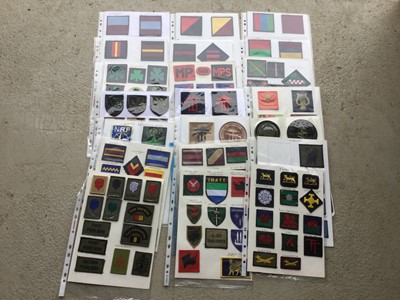 Lot 782 - 21 sheets of British, American and other cloth military badges mounted onto sheets of A4 paper