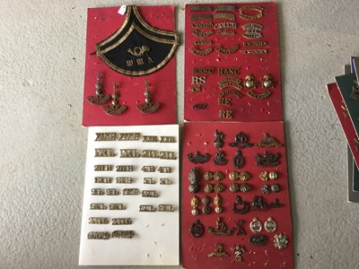 Lot 805 - Four boards each mounted with British military cap badges and shoulder titles