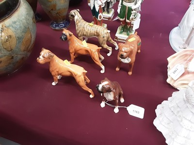 Lot 1163 - Five Royal Doulton and Beswick Boxer Dogs