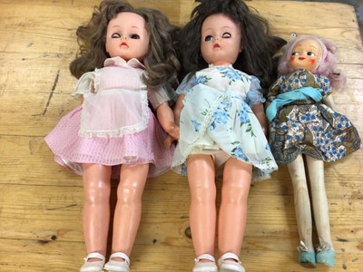 Lot 2432 - Dolls - A pair of larger English plastic dolls in original clothing including shoes. 20cms. Plus a Polish fabric doll with long legs and hard plastic painted face.