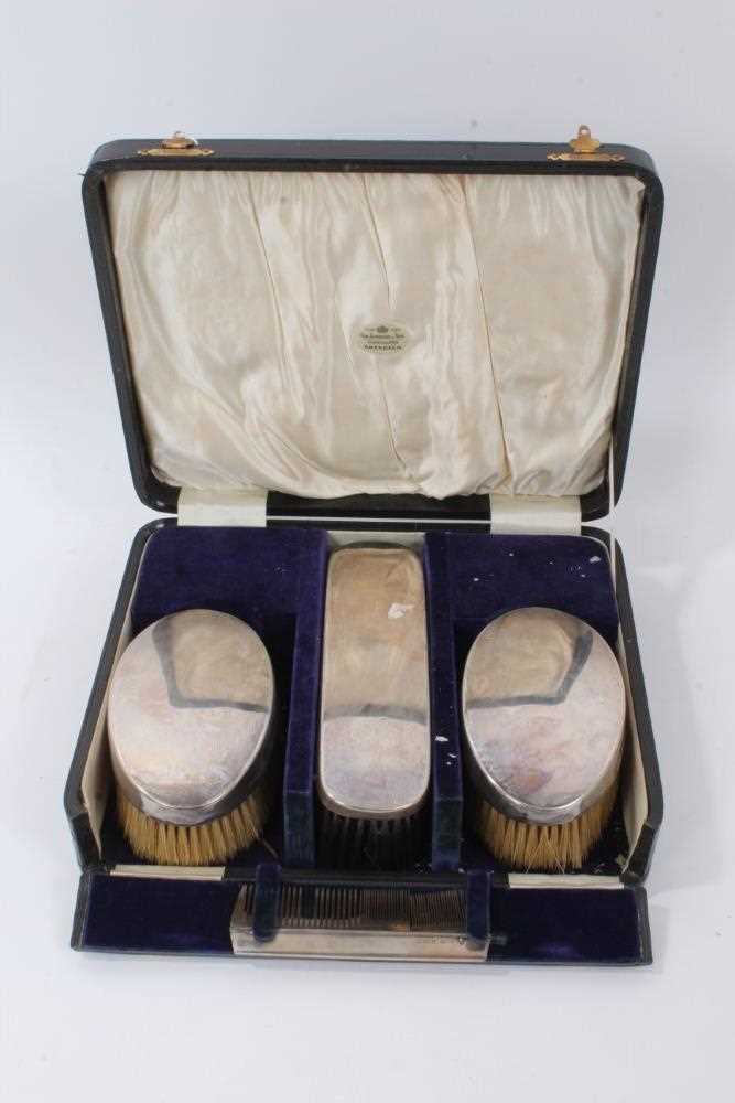 Lot 150 - George V silver dressing table set comprising three brushes and comb
