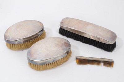 Lot 150 - George V silver dressing table set comprising three brushes and comb