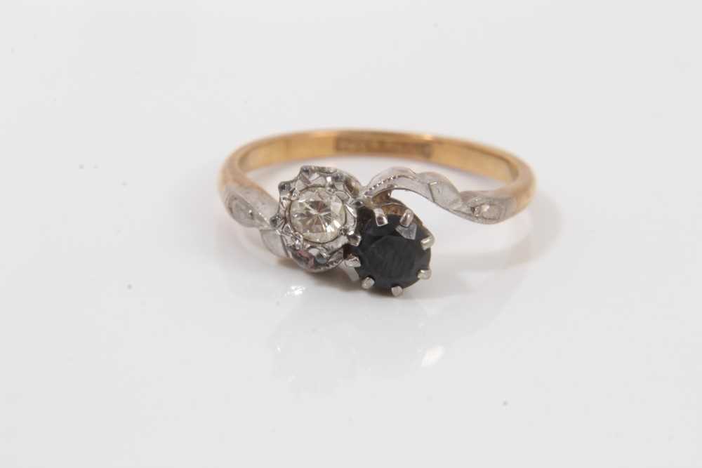 Lot 35 - 18ct gold diamond and sapphire crossover ring
