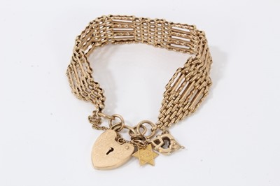 Lot 40 - 9ct gold gate bracelet with padlock clasp and two charms