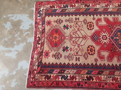 Lot 1022 - Eastern rug with geometric decoration on red, blue and beige ground, 210cm x 107cm