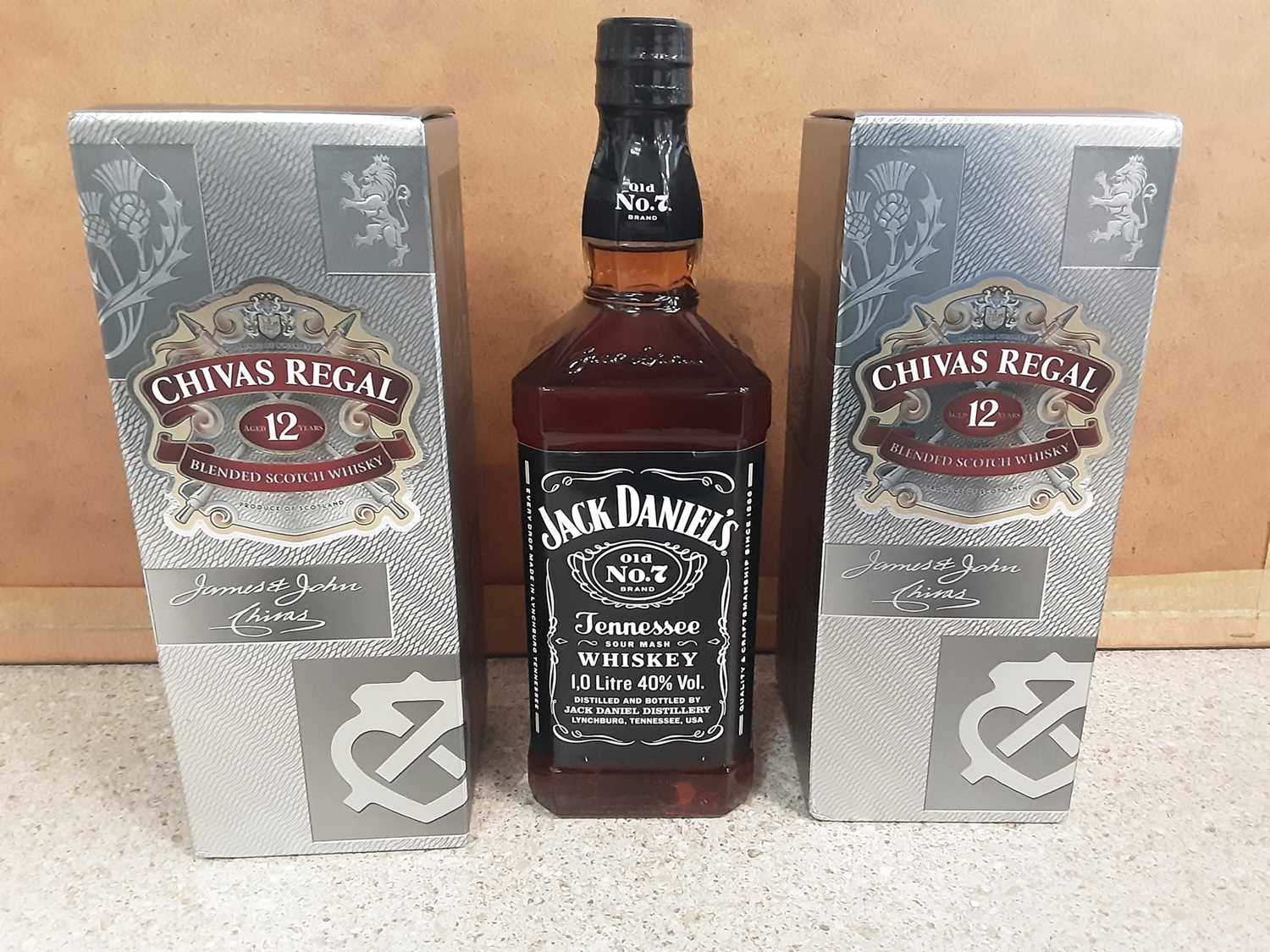 Lot 7 - Two bottles of Chivas Regal 70cl aged 12 years blended scotch whisky, in original boxes, and a 1 litre bottle of Jack Daniels (3)