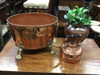 Lot 147 - Large copper wine cooler with brass lion's mask handles and paw feet, together with a copper kettle and stoneware vase