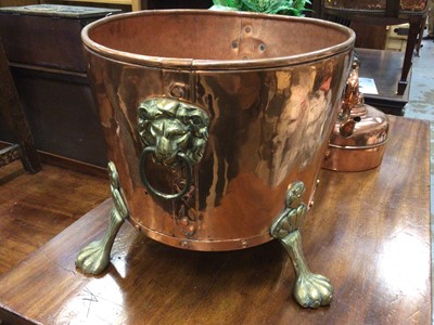 Lot 147 - Large copper wine cooler with brass lion's mask handles and paw feet, together with a copper kettle and stoneware vase