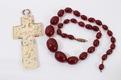 Lot 584 - Simulated cherry amber bead necklace and a 19th century Dieppe carved ivory cross pendant