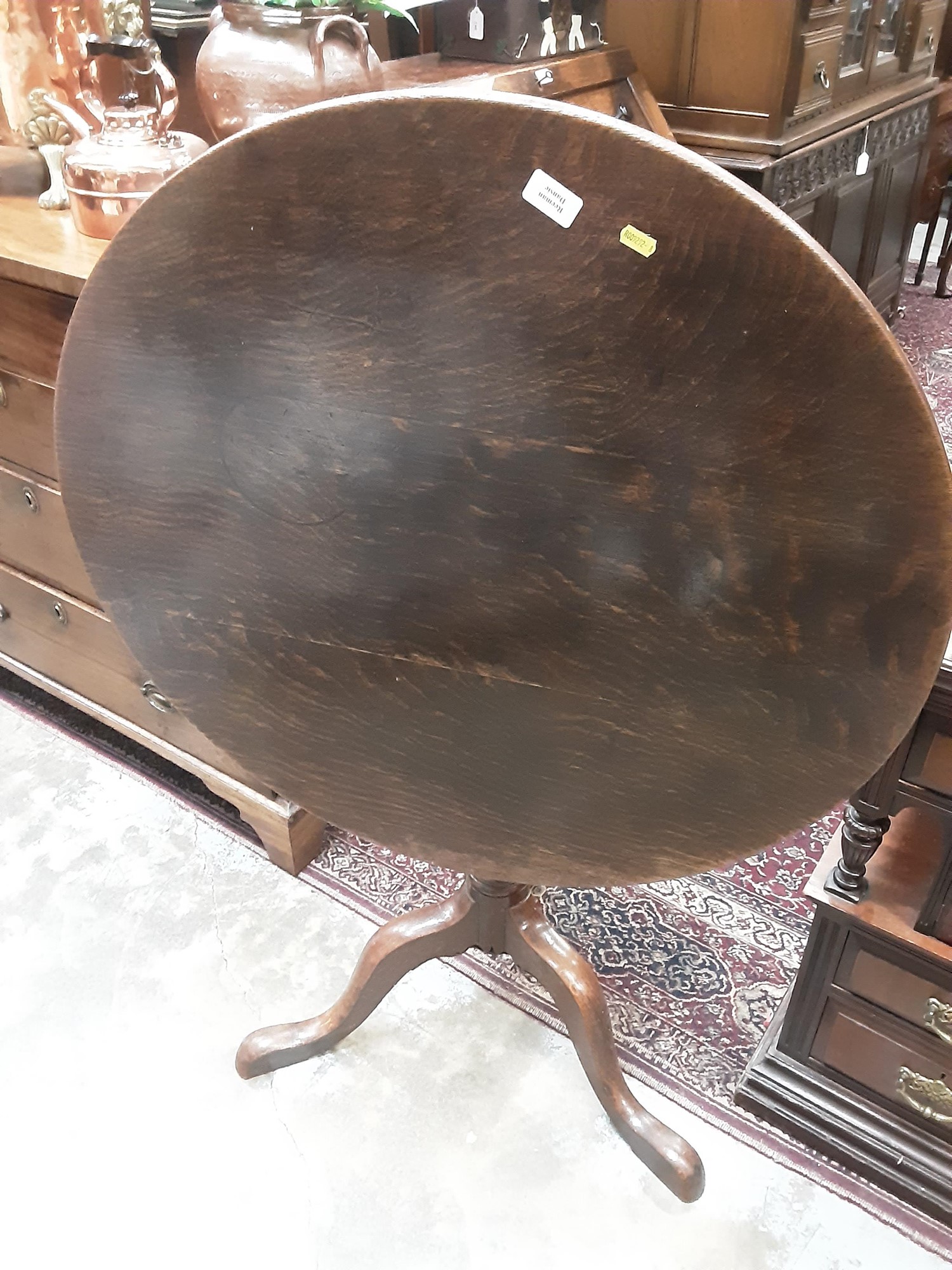 Lot 1045 - George III oak tripod table with circular