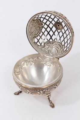 Lot 146 - Victorian silver pot pourri dome of spherical form with embossed decoration, pierced hinged cover, raised on three feet