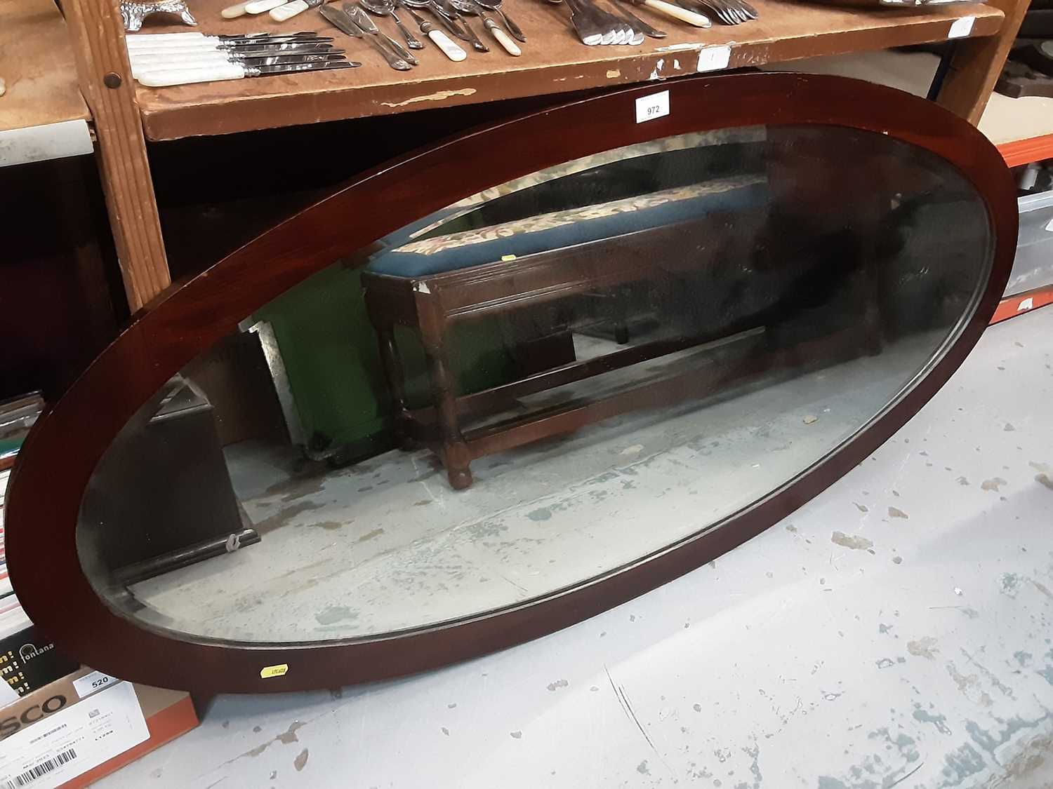 Lot 972 - Large oval bevelled wall mirror in mahogany frame, 128cm x 62cm