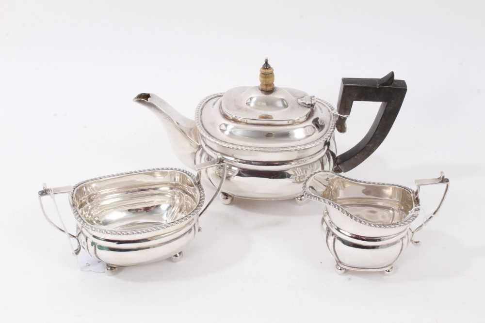 Lot 153 - George V Bachelors silver teaset comprising teapot of cauldron form with gadrooned border, raised on ball feet, together with matching milk jug and sugar bowl