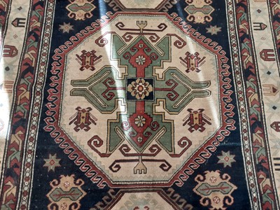 Lot 1108 - Eastern rug with geometric decoration on blue, red and cream ground, 204cm x 145cm