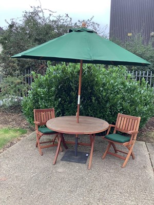 Lot 899 - Garden set comprising folding table, four matching chairs with cushions, parasol and stand