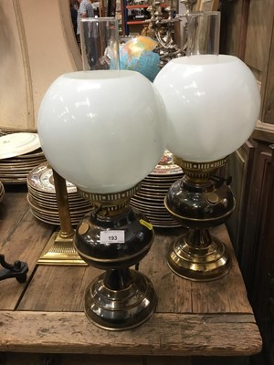 Lot 93 - Two pairs of brass oil lamp style table lamps, two pairs of brass candlesticks table lamps and a gothic wrought metal lamp