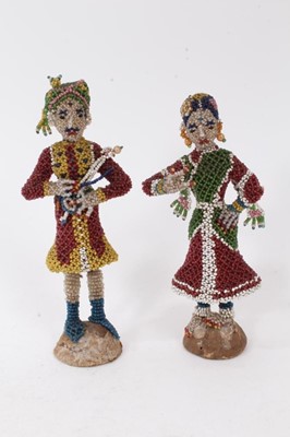 Lot 795 - Pair of early 20th century Indian figures with glass beadwork decoration