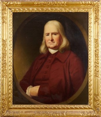 Lot 1039 - English School, early 18th century, oil on canvas laid on board - half length portrait of a Gentleman in red coat, painted within an oval, 74cm x 61cm, in period carved giltwood frame